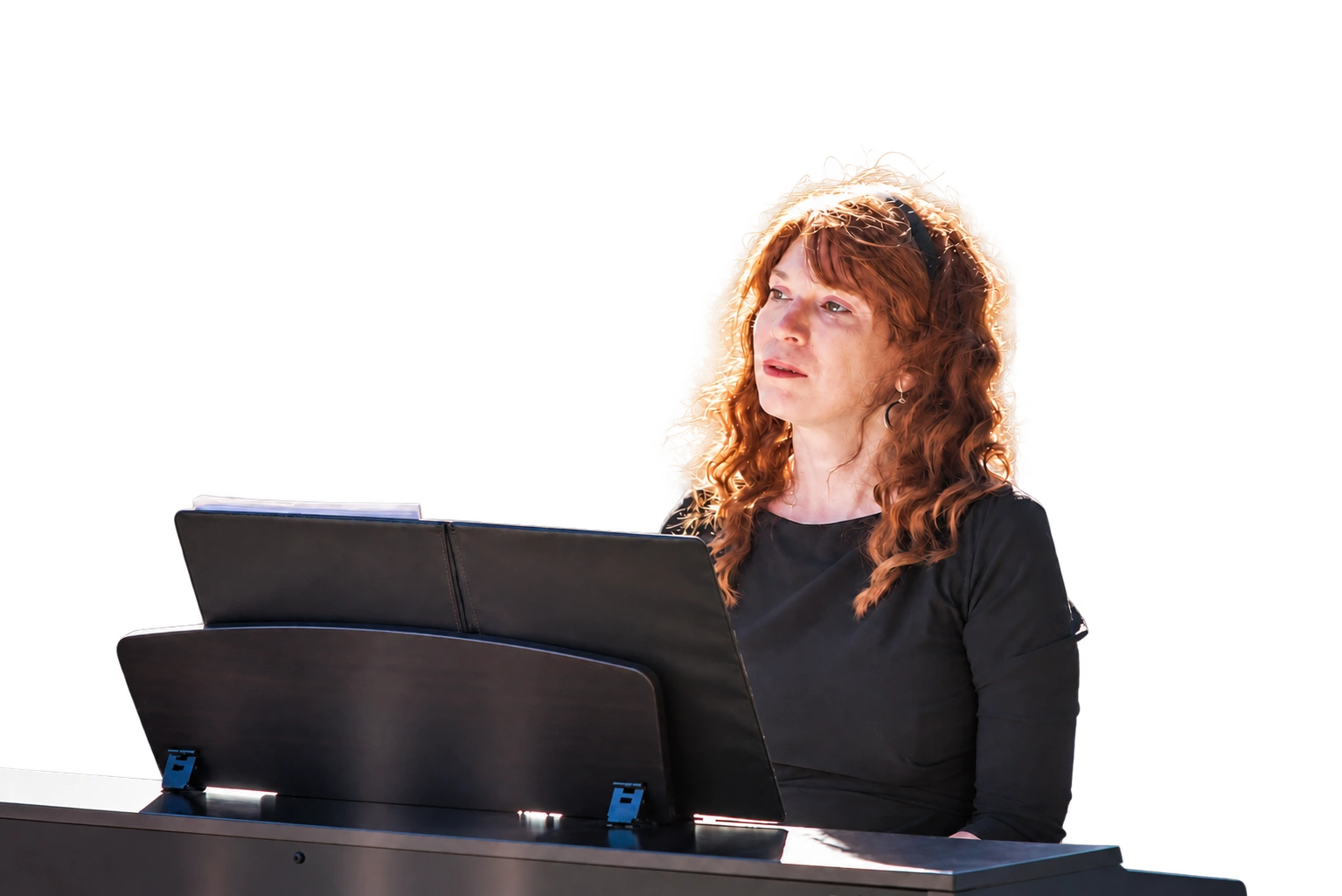 Jenny playing piano outdoors, with her music binder and piano